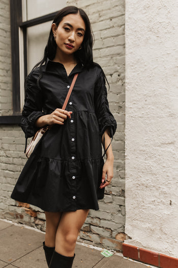 utton up dress paired with a long leather boots