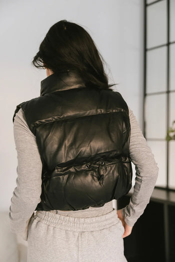sinched back on black vest
